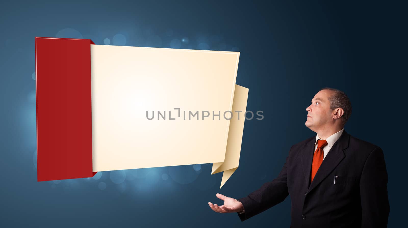 businessman in suit presenting modern origami copy space