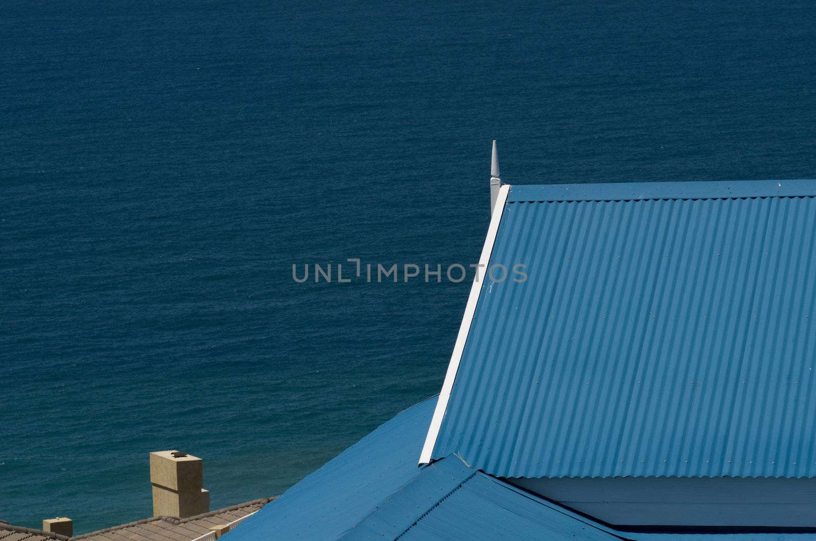 Roof and ocean blue and white Mediteranean style holiday house