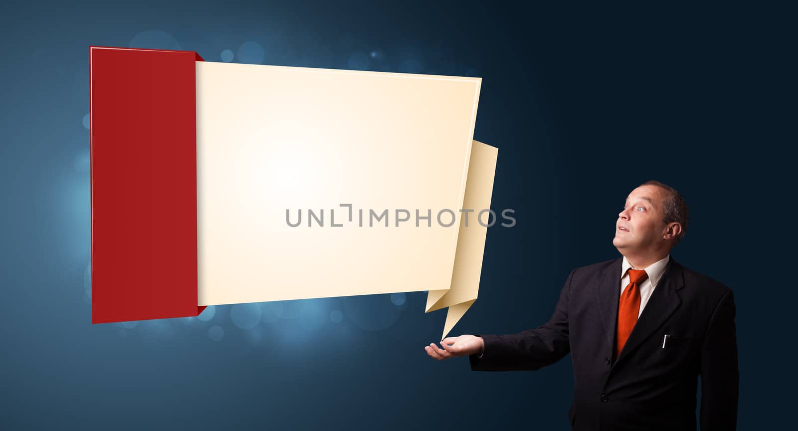 businessman in suit presenting modern origami copy space