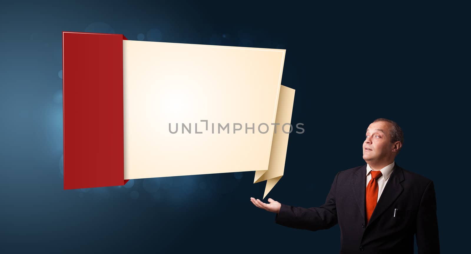 businessman in suit presenting modern origami copy space