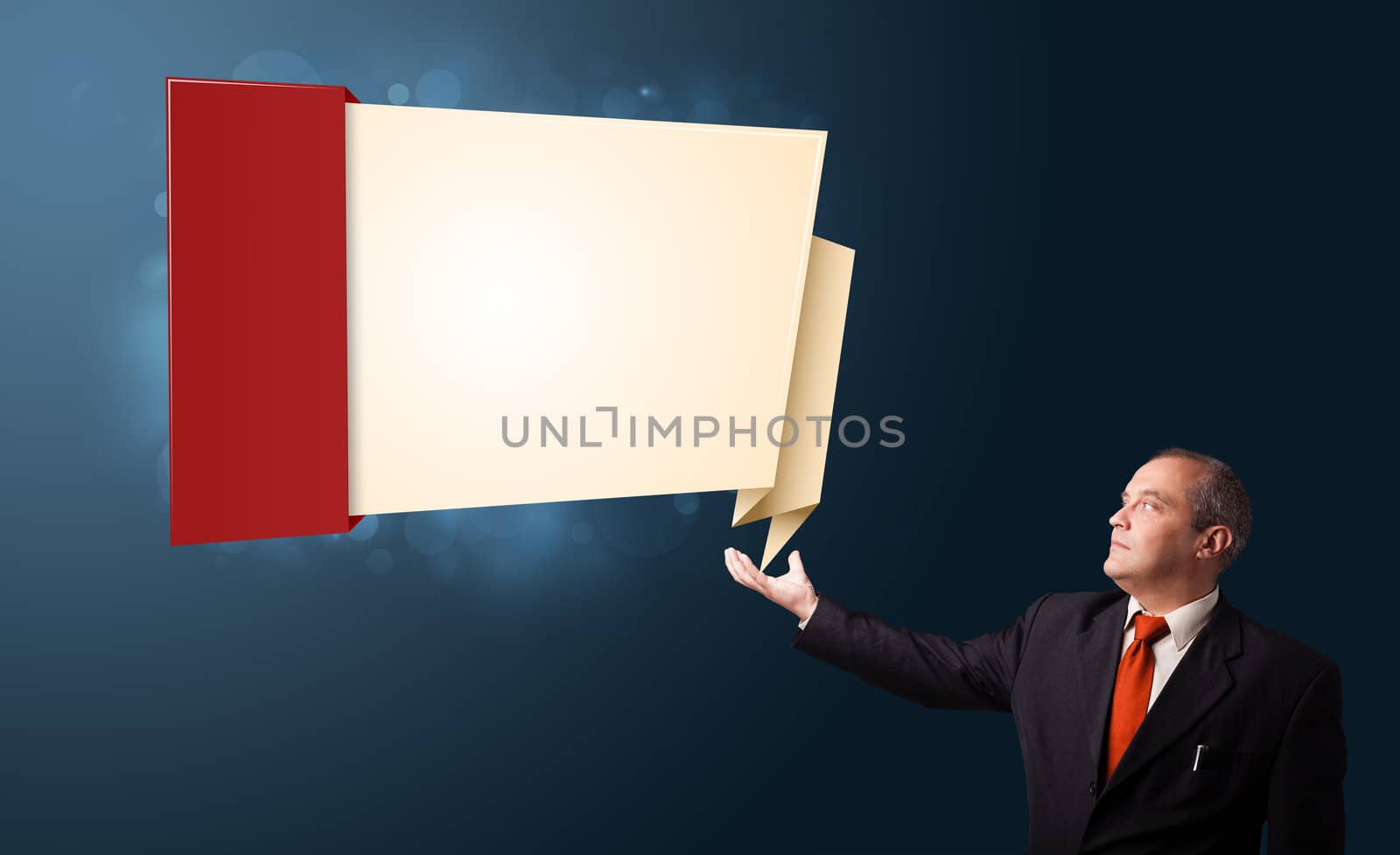 businessman in suit presenting modern origami copy space