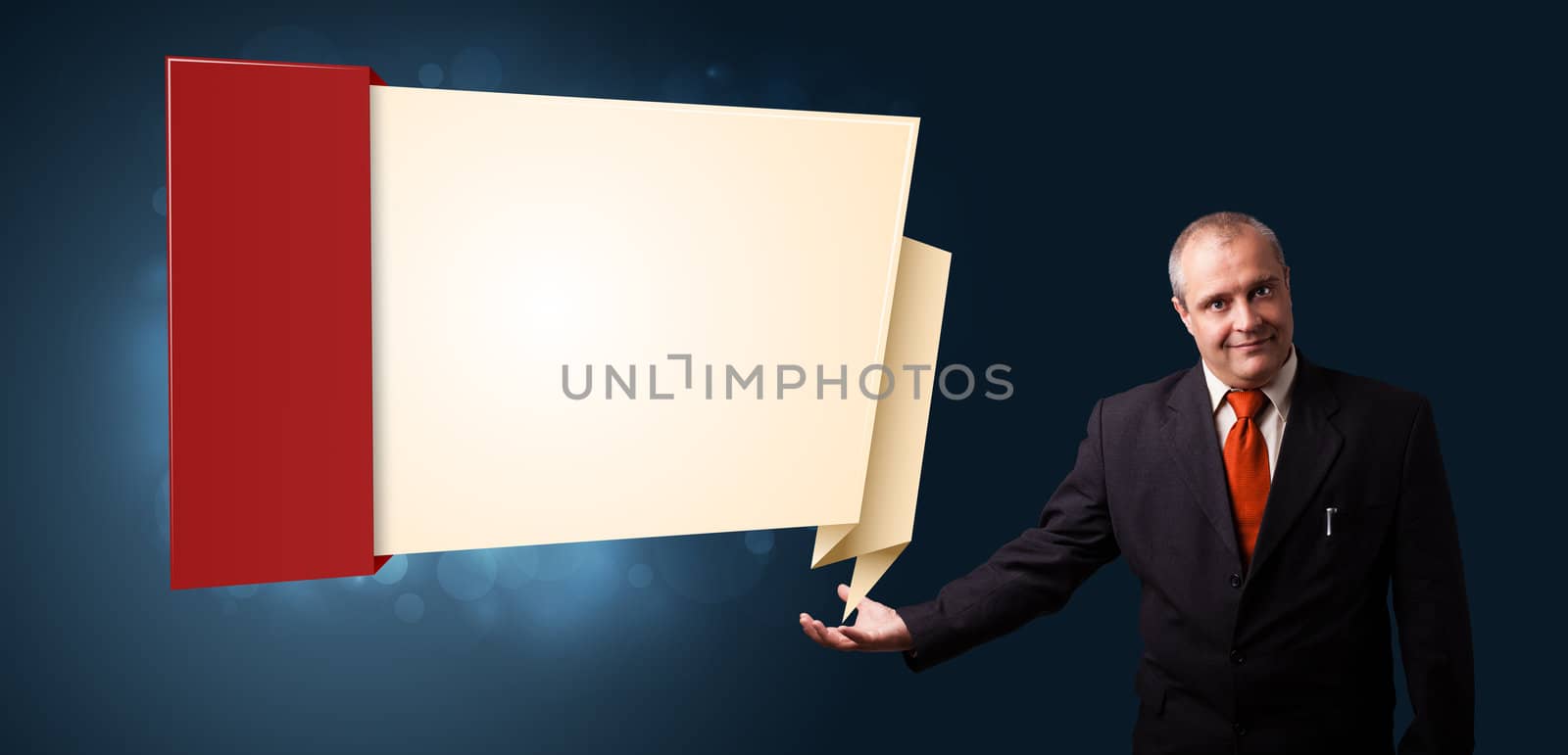 businessman in suit presenting modern origami copy space