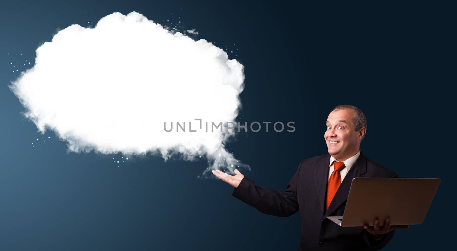 Businessman in suit holding a laptop and presenting abstract cloud copy space