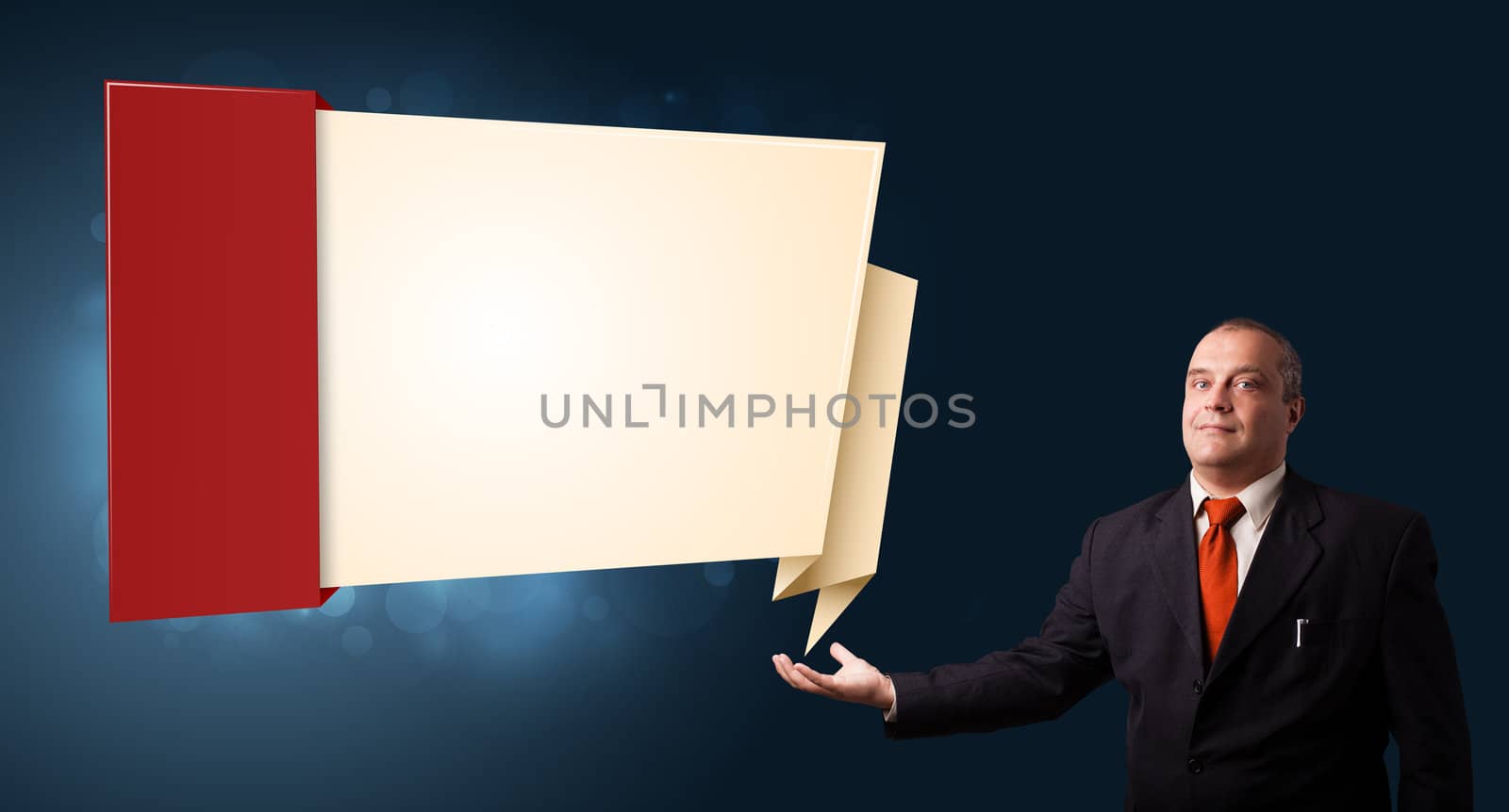 businessman in suit presenting modern origami copy space