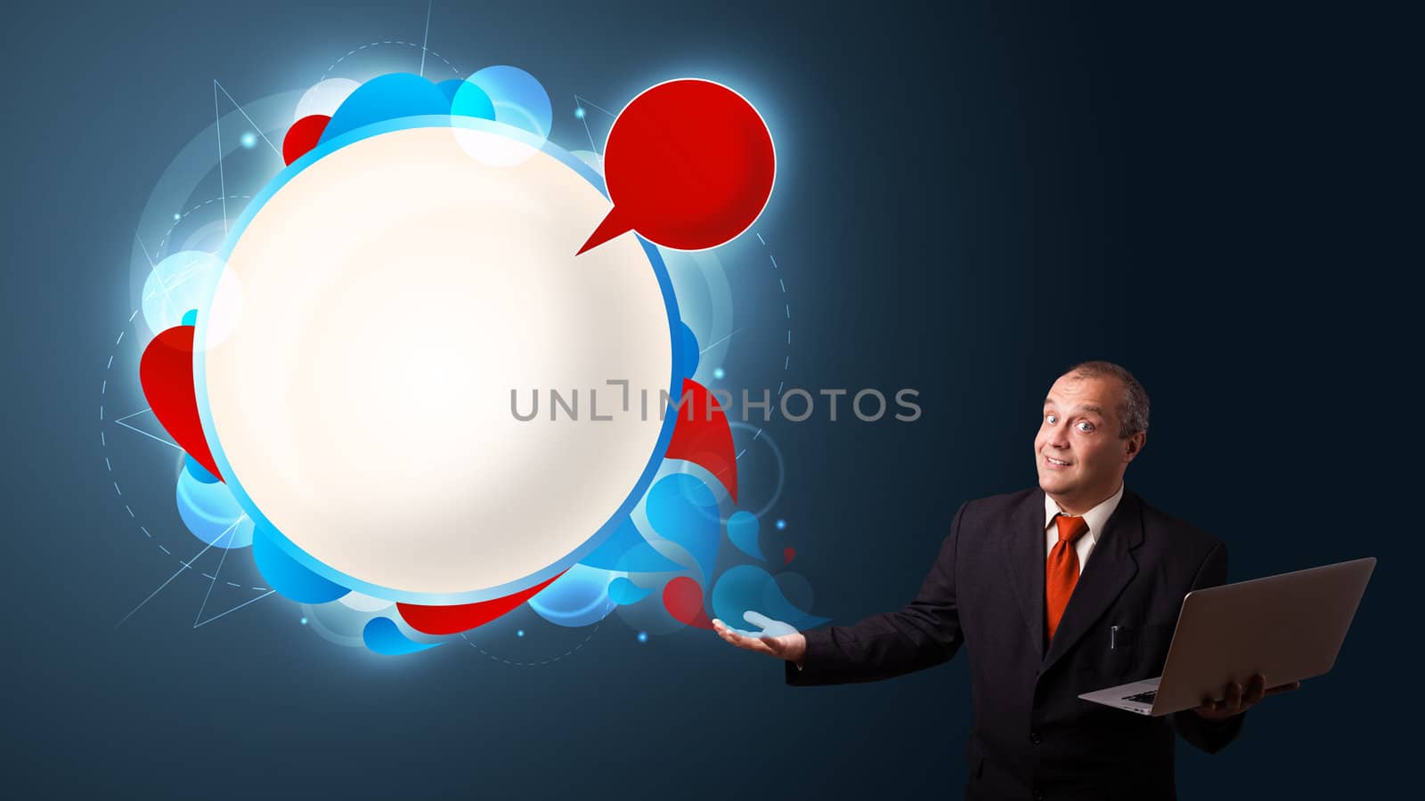 Businessman in suit holding a laptop and presenting abstract modern speech bubble with copy space