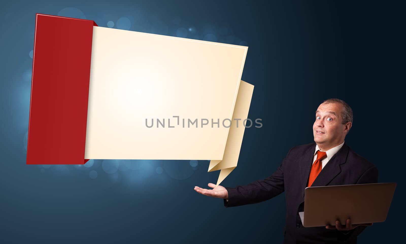 Businessman in suit holding a laptop and presenting modern origami copy space