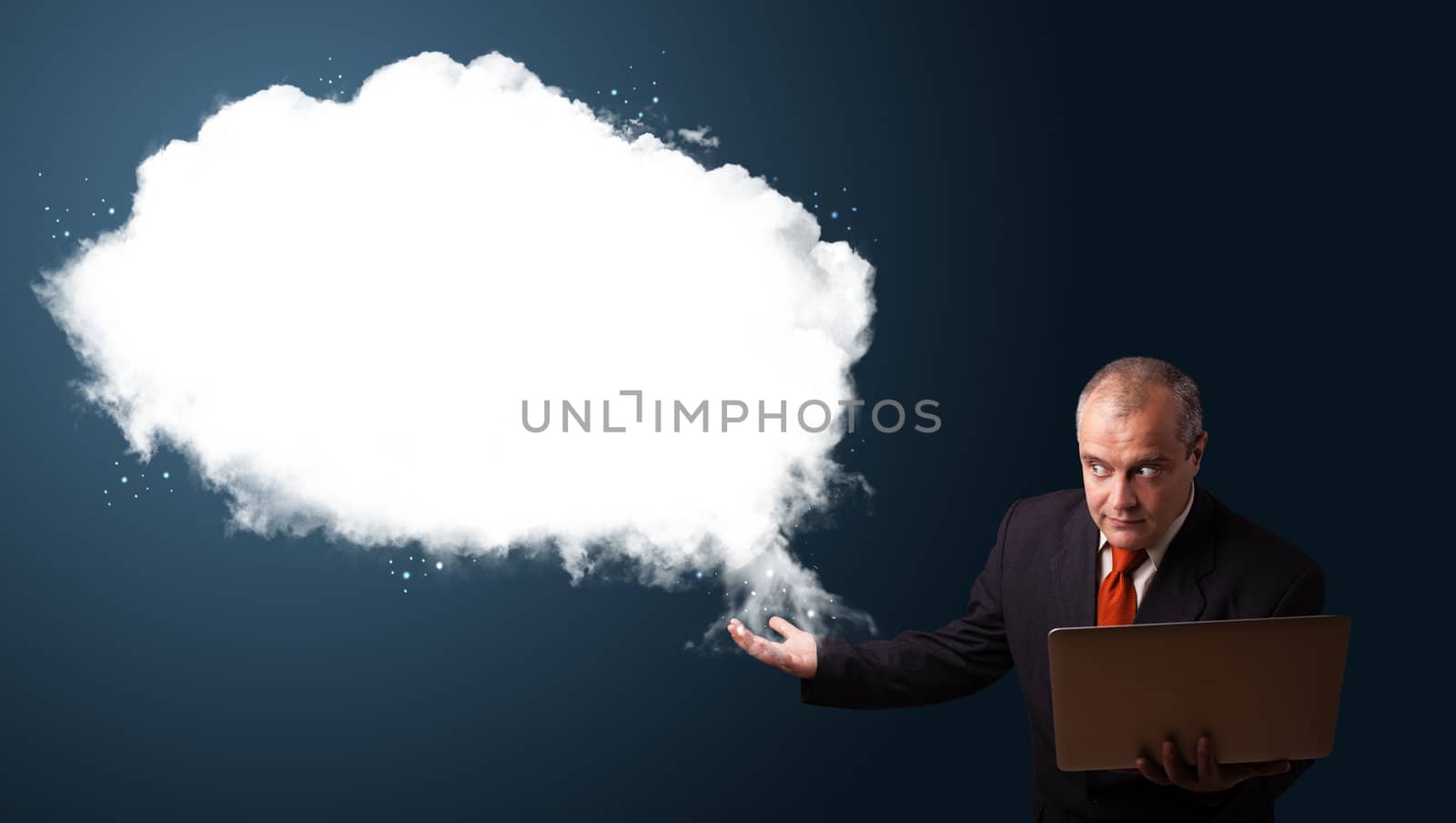 Businessman holding a laptop and presenting abstract cloud copy  by ra2studio