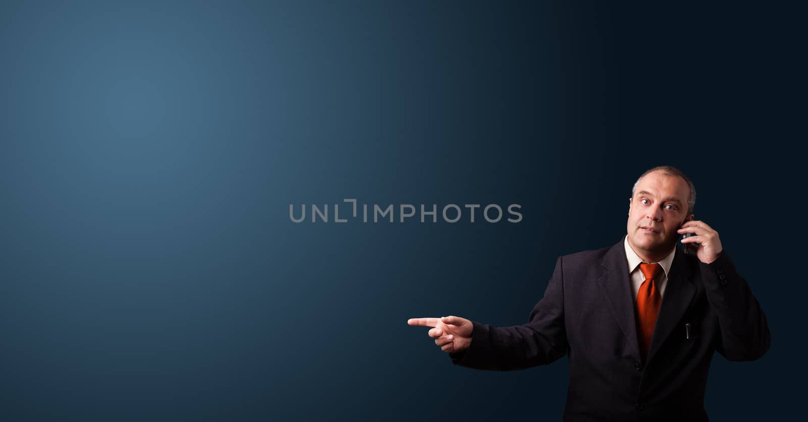 businessman in suit making phone call and presenting copy space