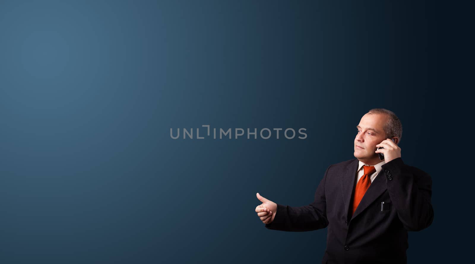 businessman in suit making phone call and presenting copy space