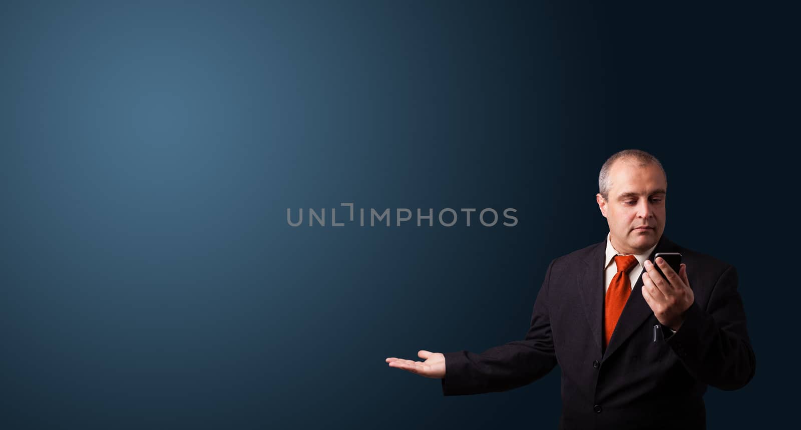 businessman in suit making phone call and presenting copy space