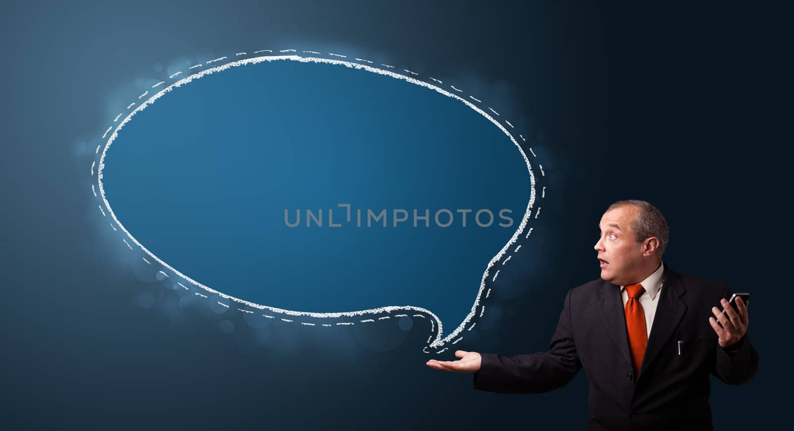 funny businessman in suit holding a phone and presenting speech bubble copy space