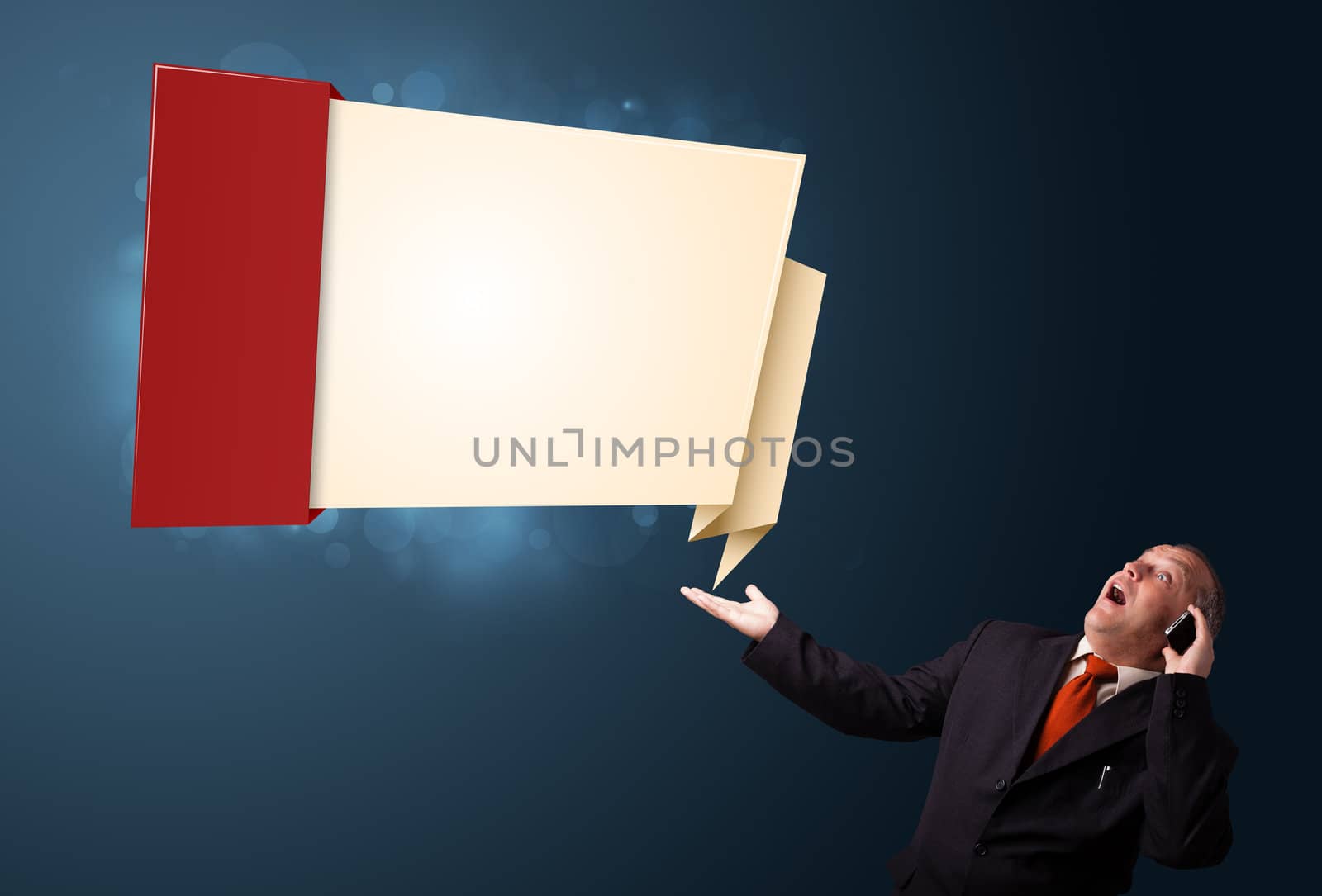 crazy businessman in suit holding a phone and presenting modern origami copy space