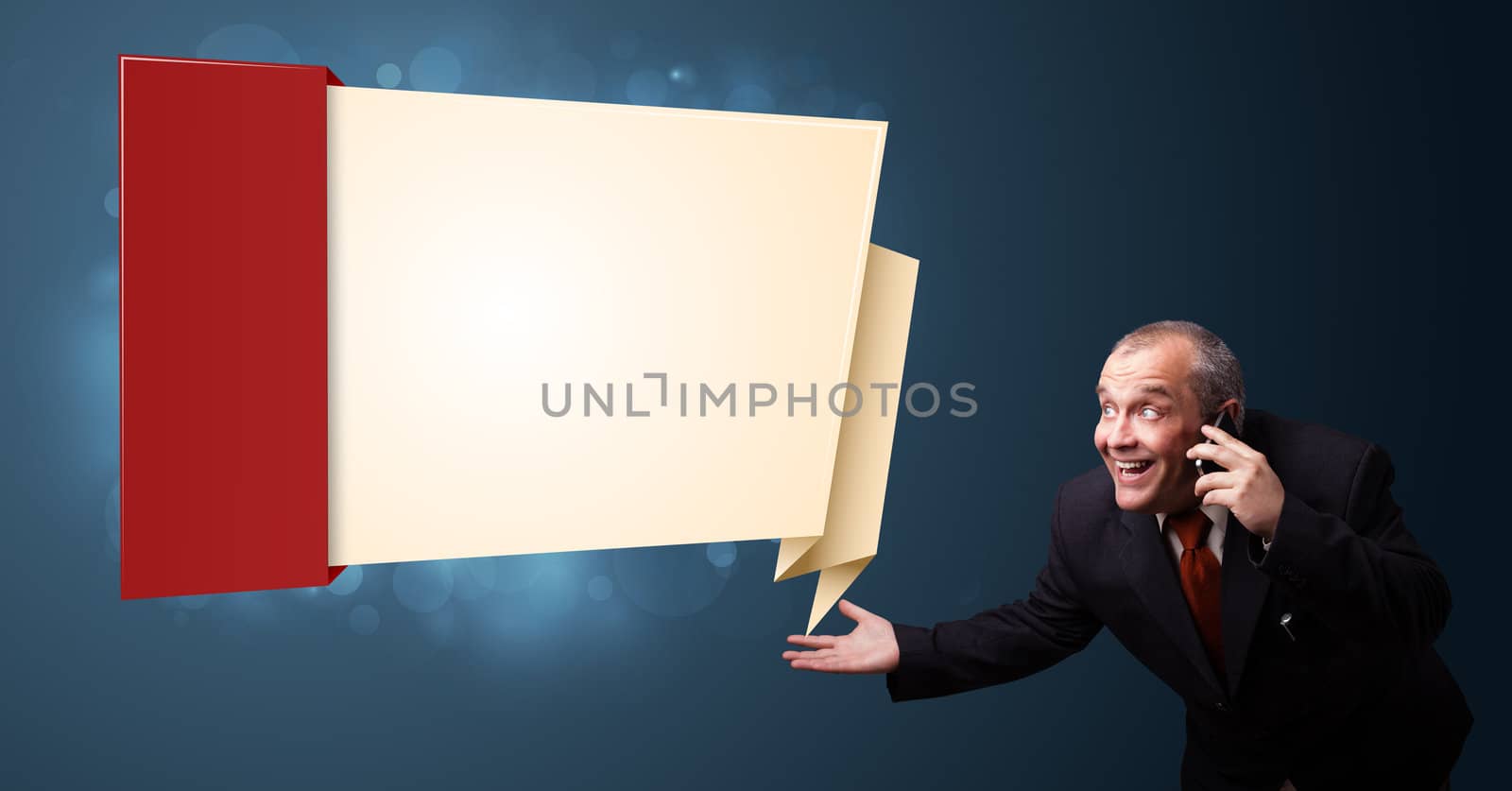 crazy businessman in suit holding a phone and presenting modern origami copy space