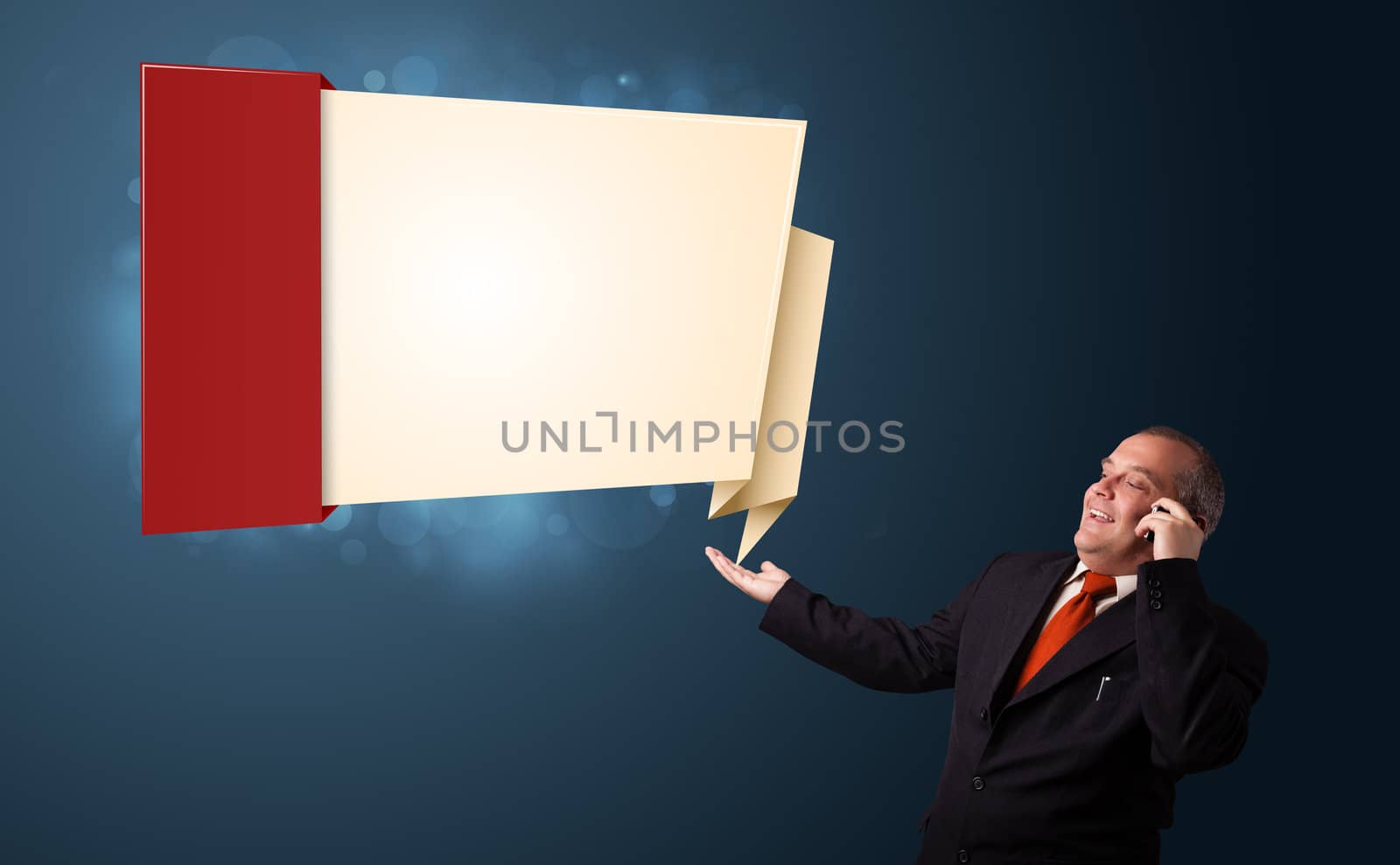 crazy businessman in suit holding a phone and presenting modern origami copy space