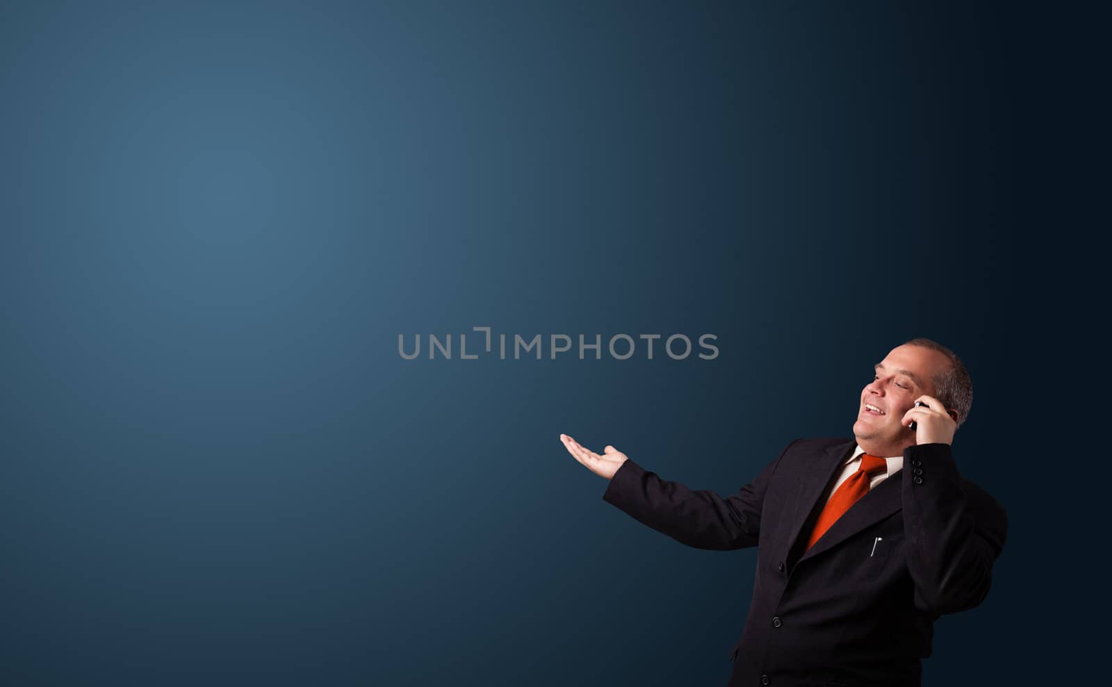 businessman in suit making phone call and presenting copy space