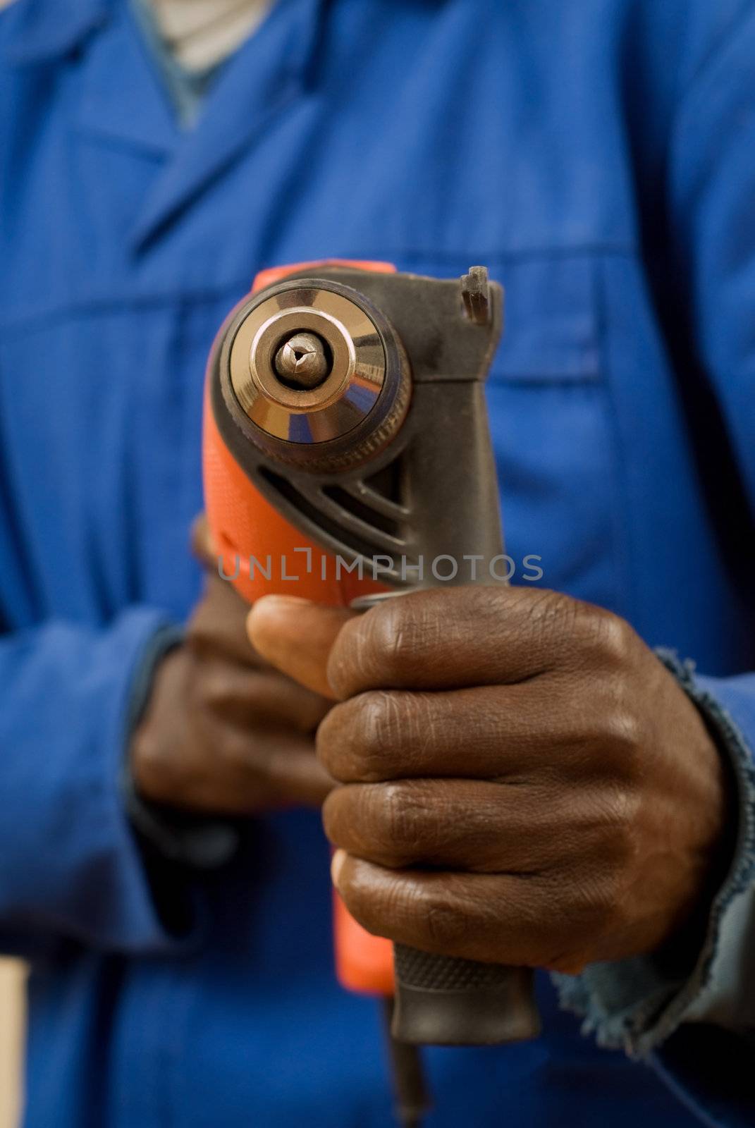 Close up of construction worker with power tool in hands