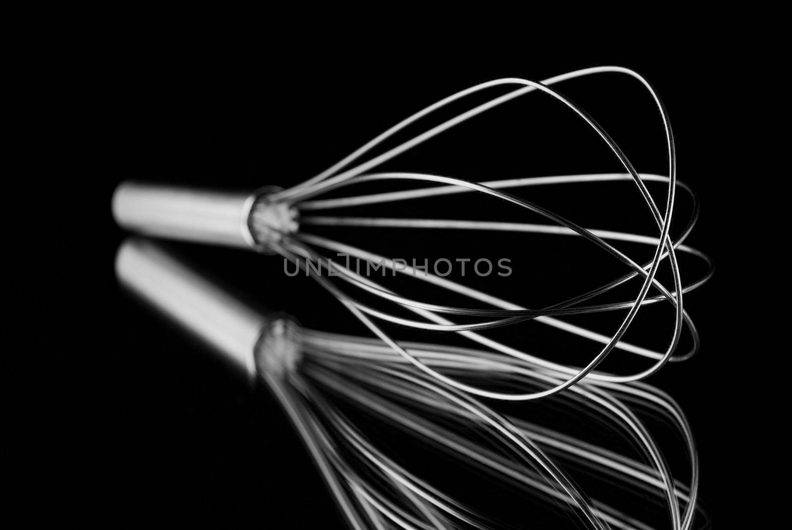 Single whisk reflection with black background