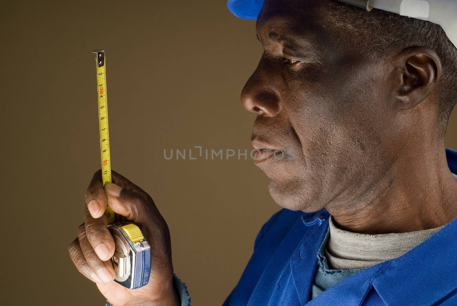 African American Construction Worker Holding a Tape Measure