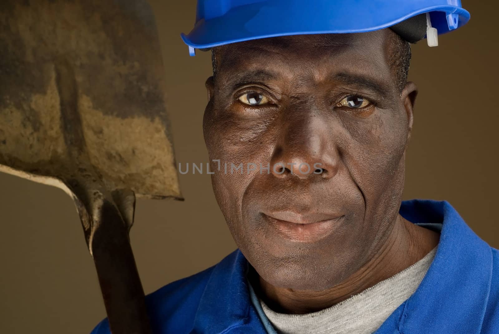 African American Construction Worker Resting Shovel on His Shoulder