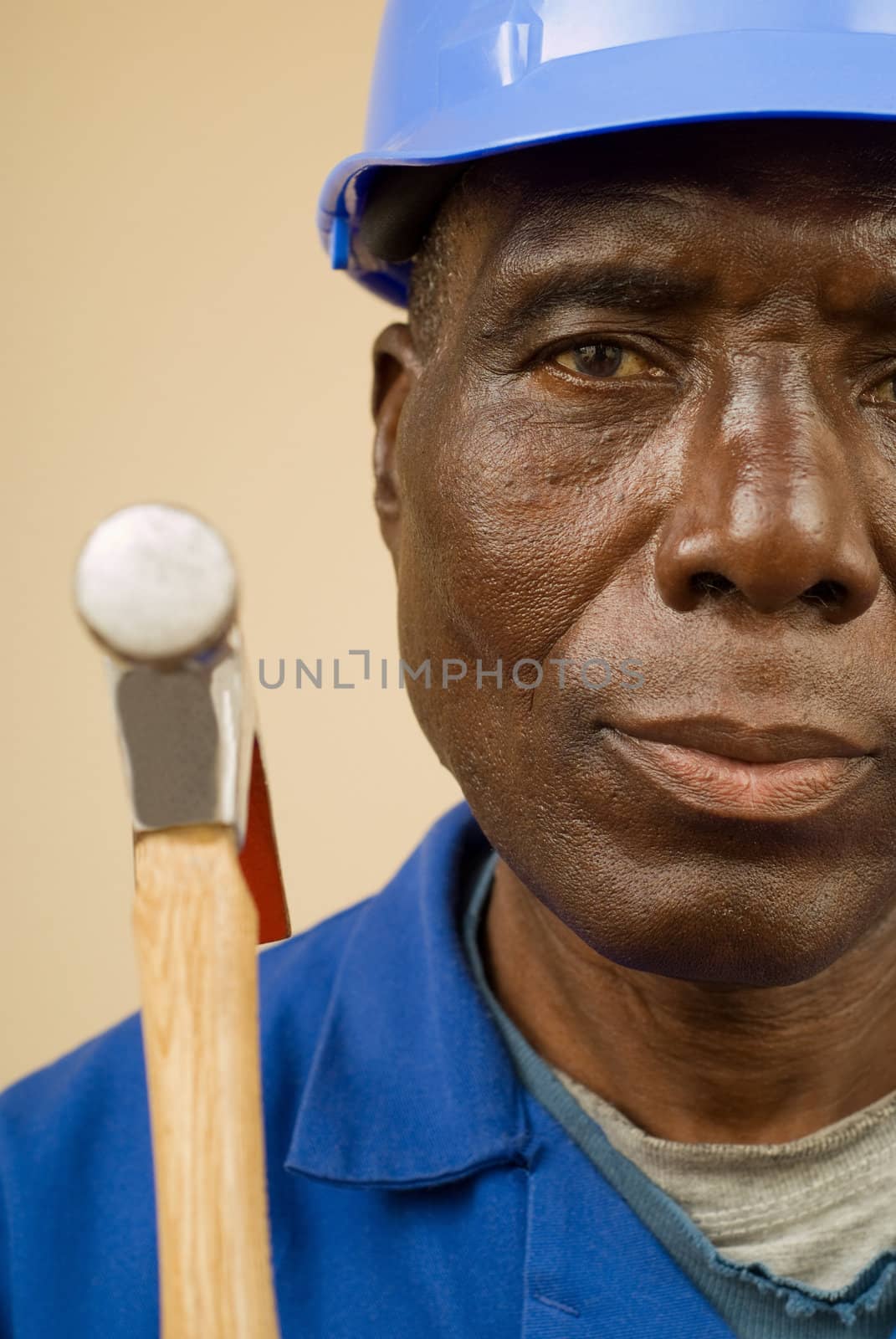 Construction worker holding hammer, builder, handyman
