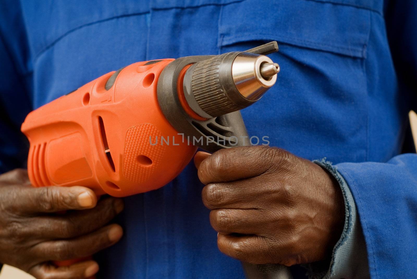 African American Construction Worker Holding Power Tool in Hands