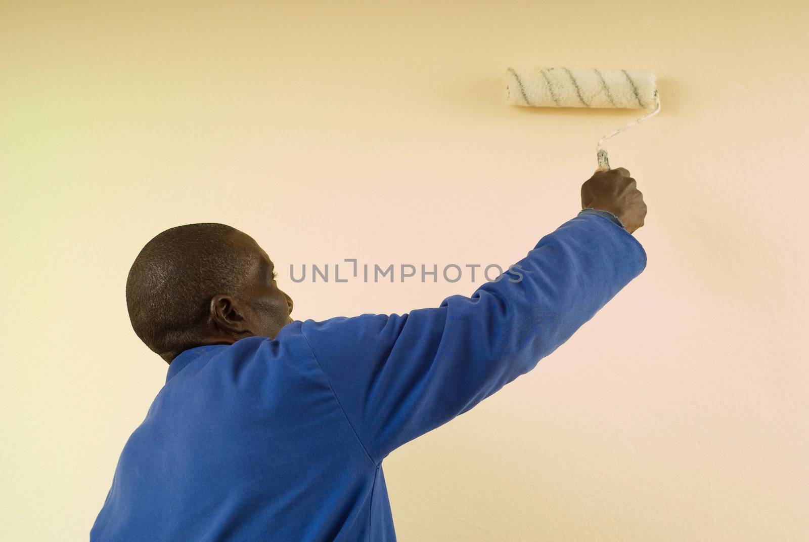 African American Construction Worker Painting a Wall