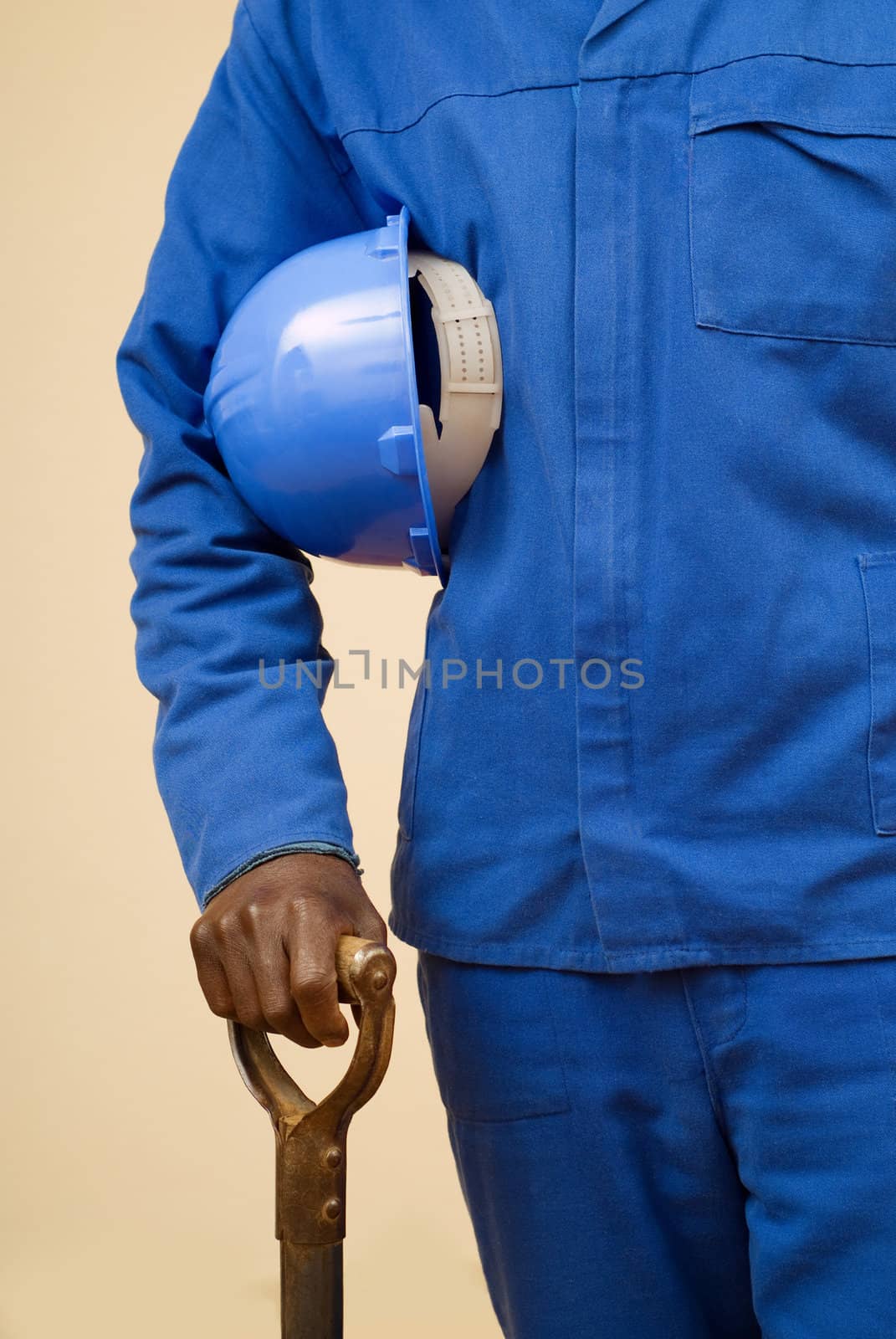 Close up of construction worker holding shovel and blue hard hat