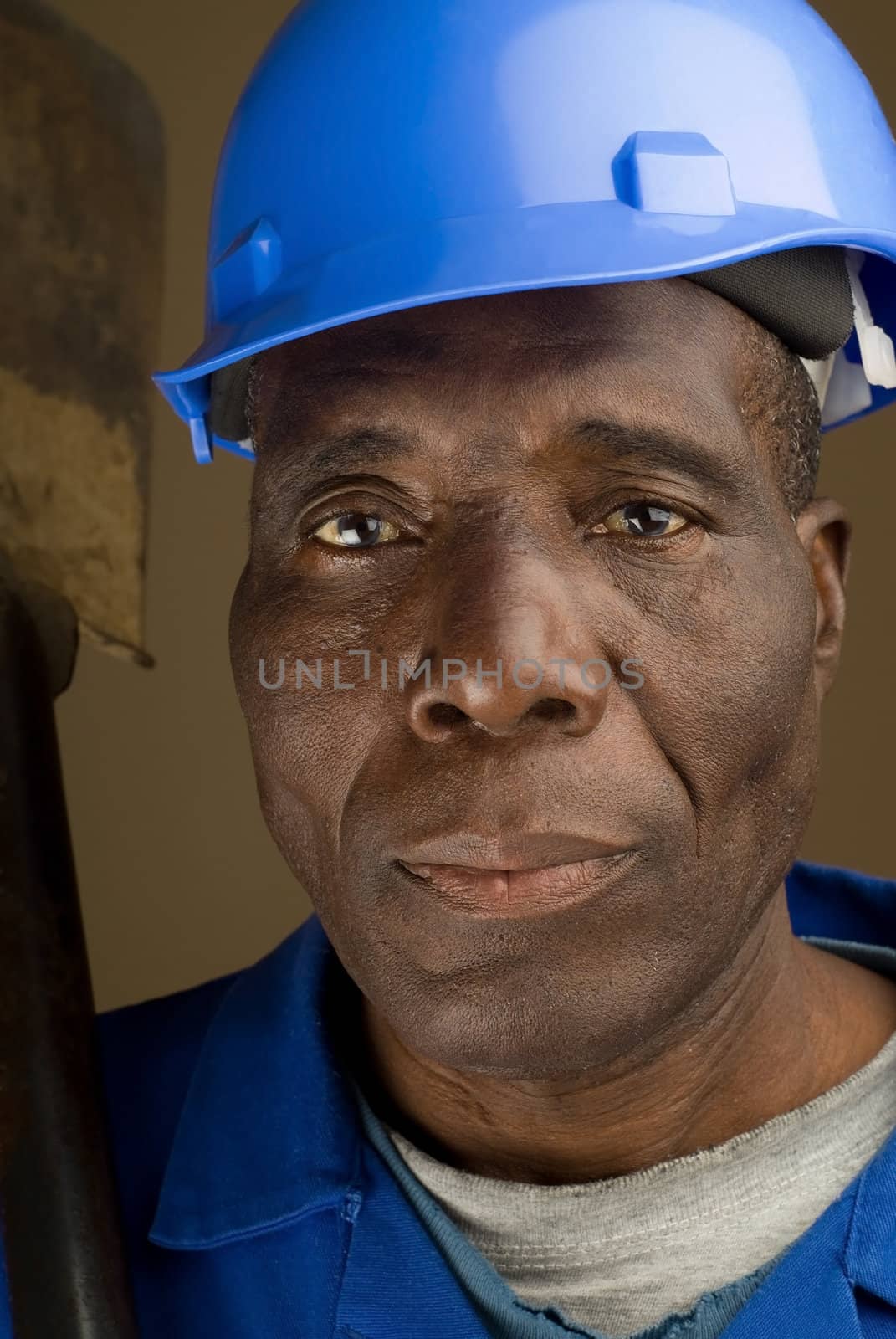 African American Construction Worker Resting Shovel on His Shoulder