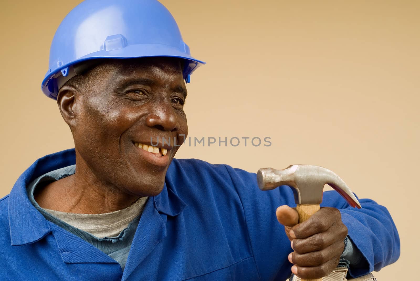 Smiling African American Construction Worker Holding Hammer
