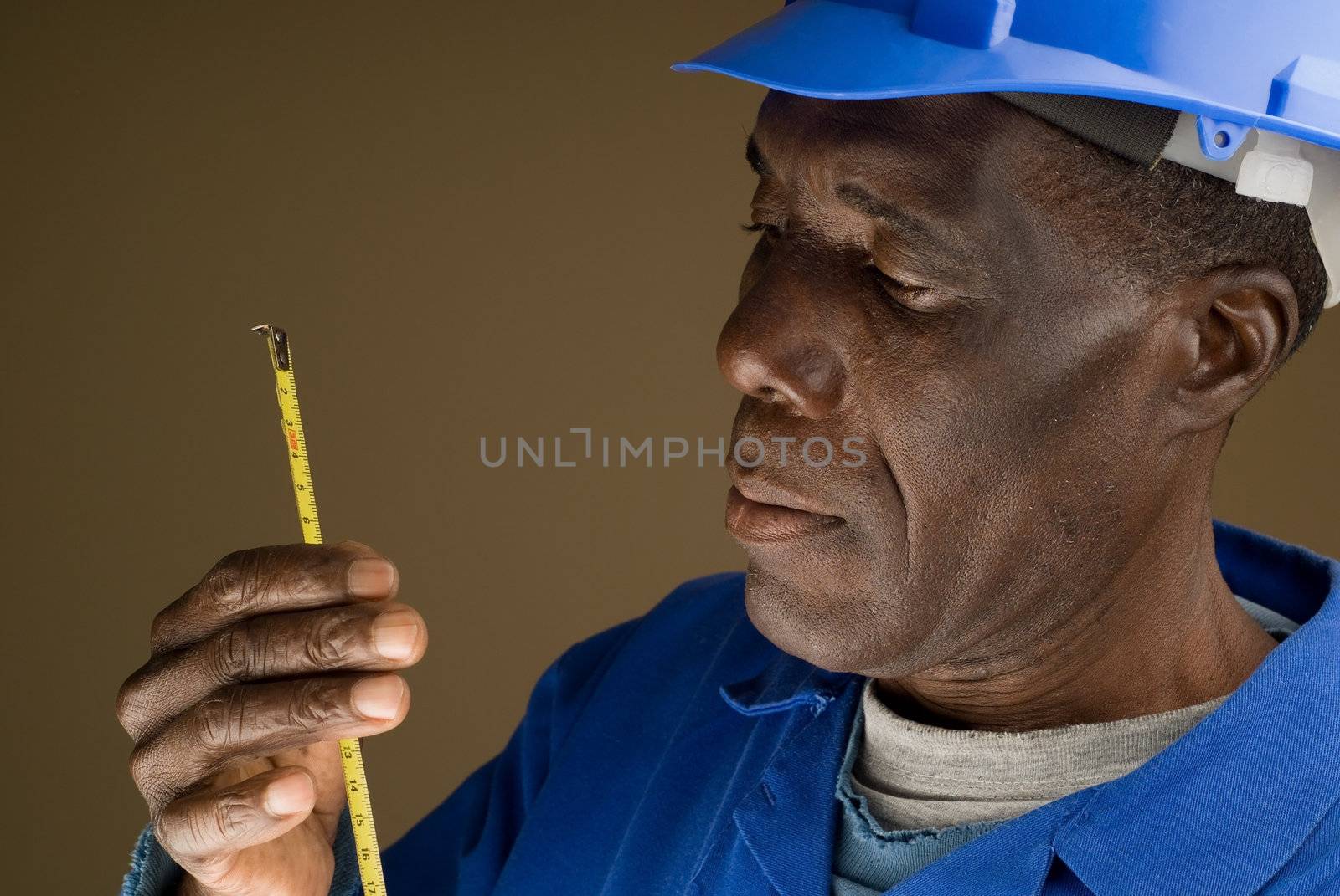 Construction Worker with Measuring Tool by alistaircotton