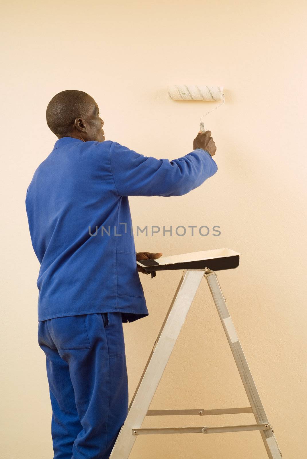 African American Construction Worker Painting a Wall