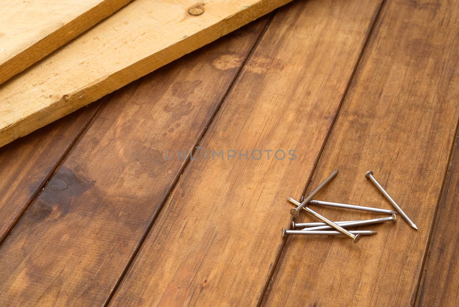 Nails and planks on a wooden table