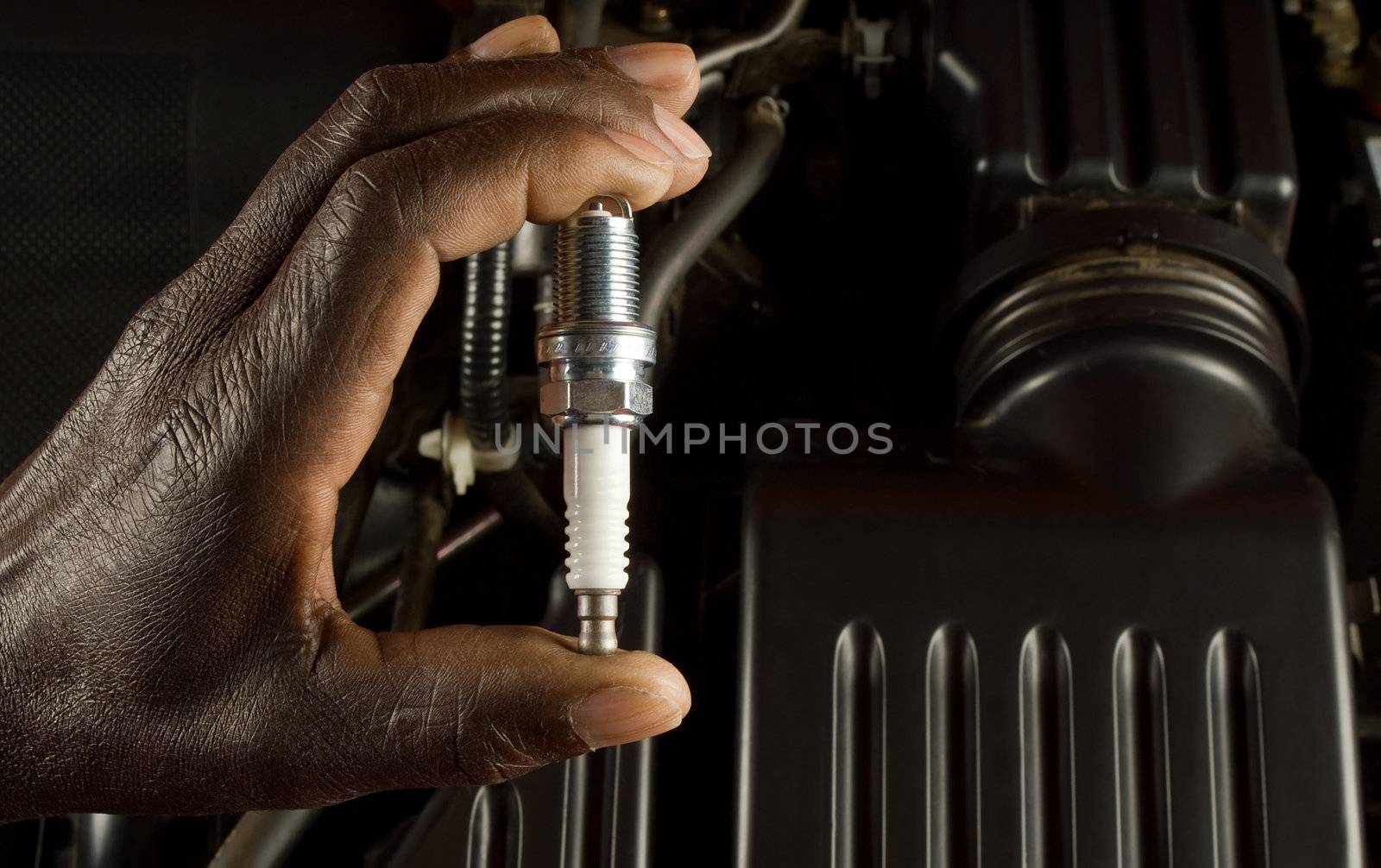 Mechanic holding spark plug by alistaircotton