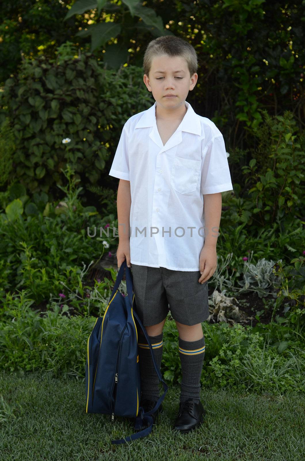 Schooboy sad or unhappy at first day of school