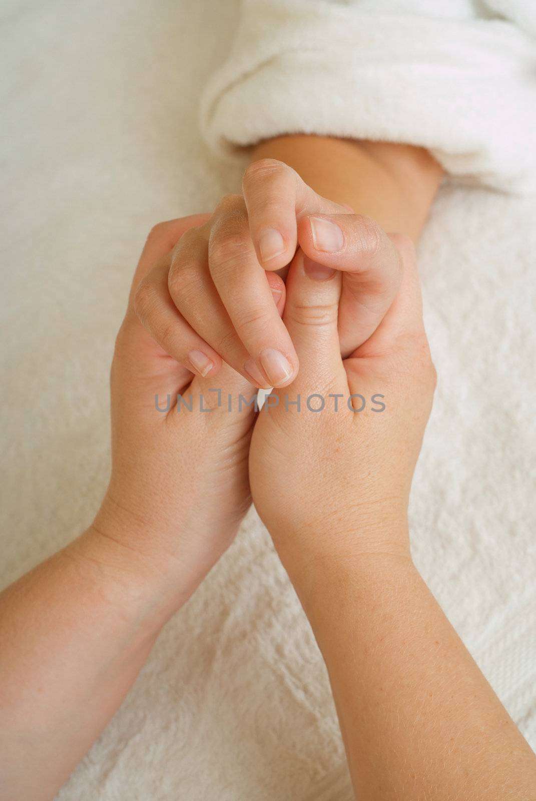Beauty therapist hands massaging hands or manicure