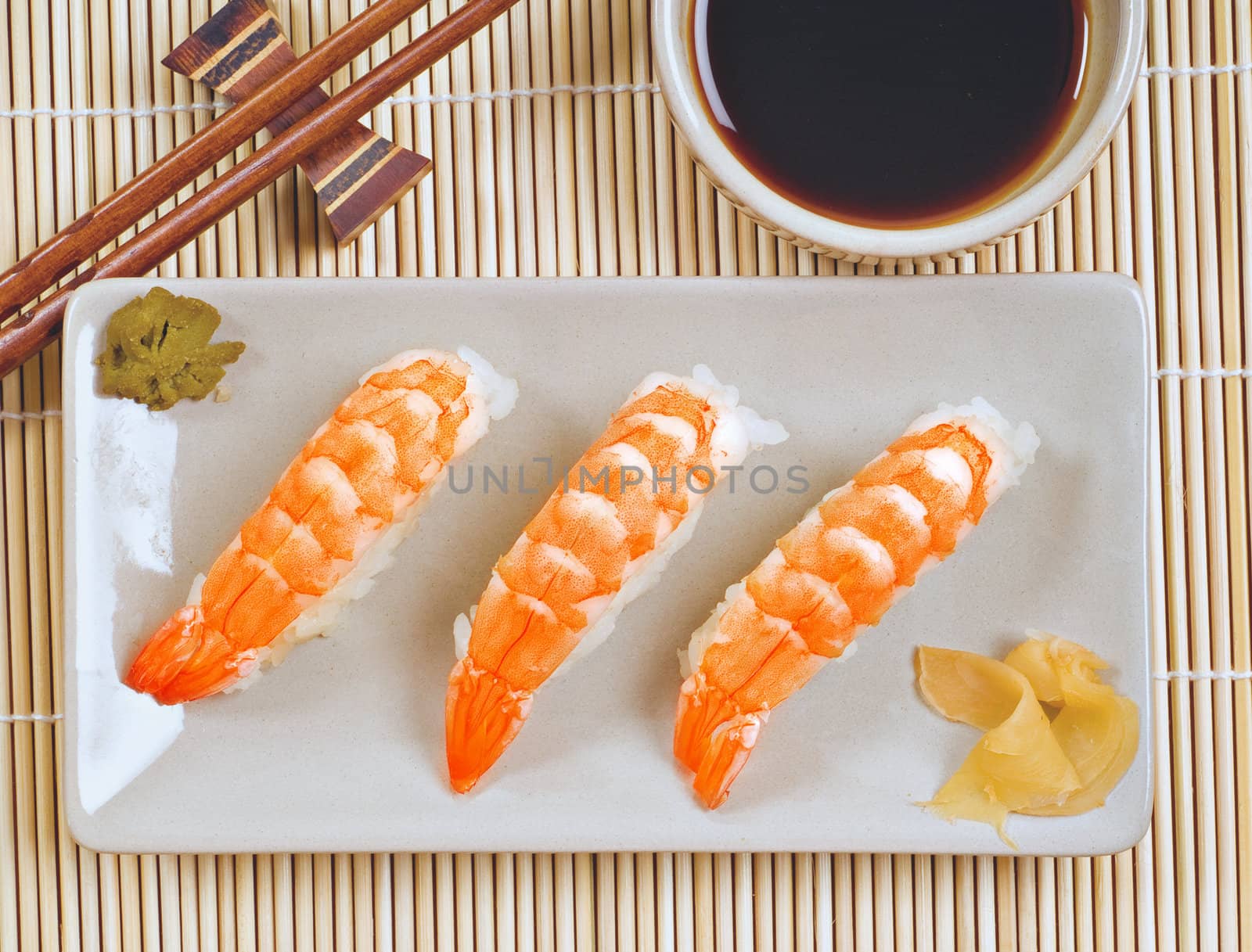 Platter of sushi prawn plate with chopsticks, soya sauce