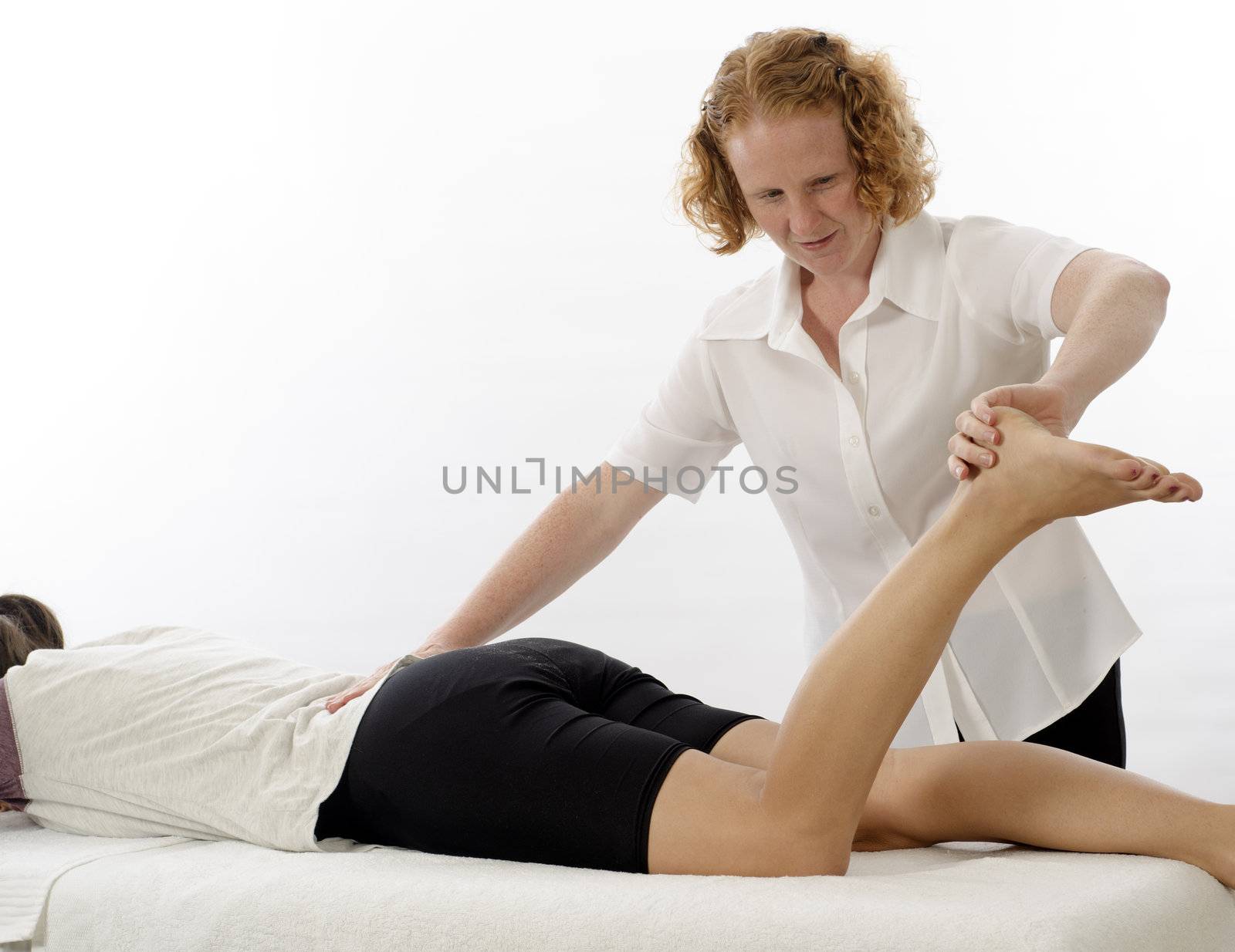 Kinesiologist or physiotherapist treating foot