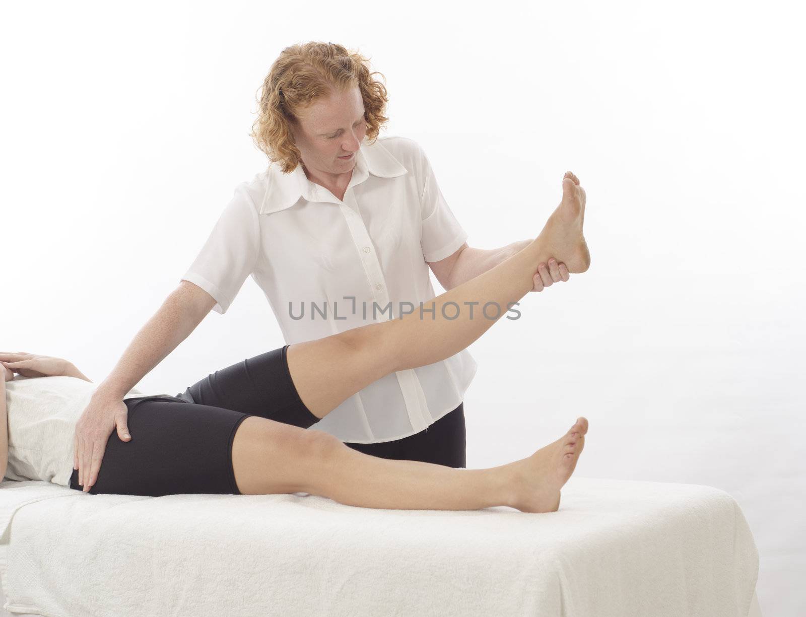 Kinesiologist treating leg by alistaircotton