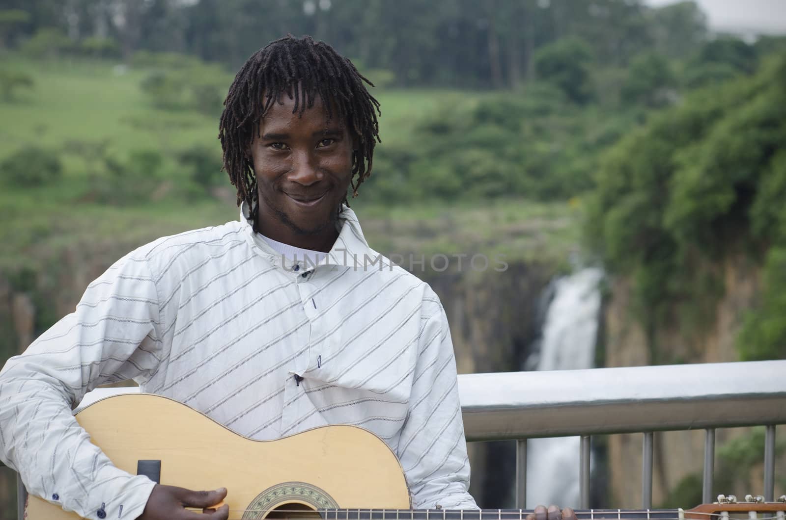 African busker in front of Howick Falls by alistaircotton