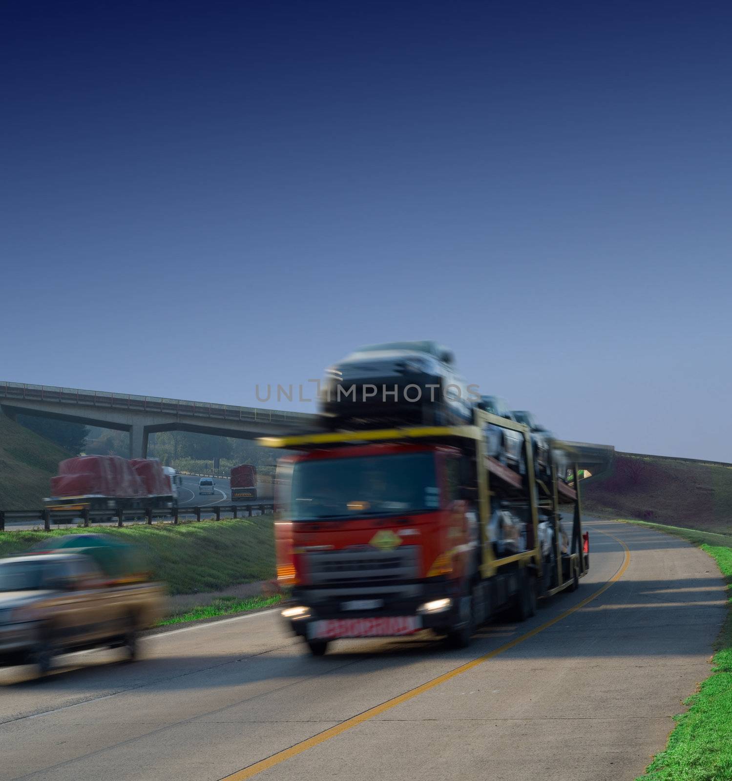 Car transport cargo truck with with motion blur on highway