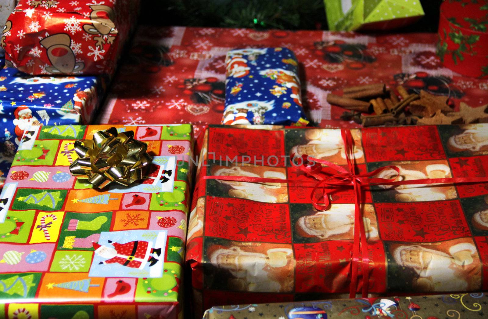 Lot of Christmas gifts wrapped in the beautiful vivid paper 
