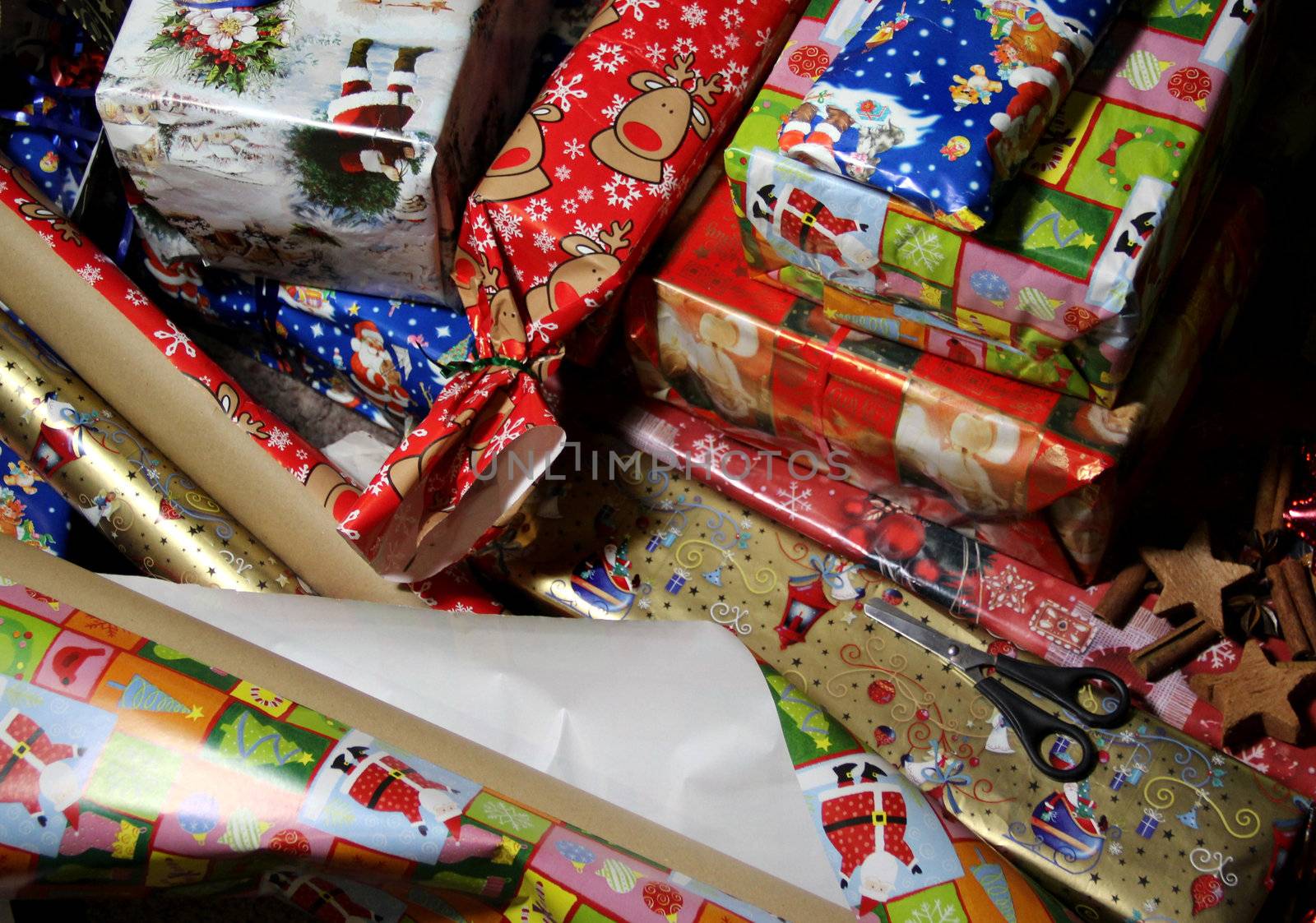 Lot of Christmas gifts wrapped in the beautiful vivid paper 