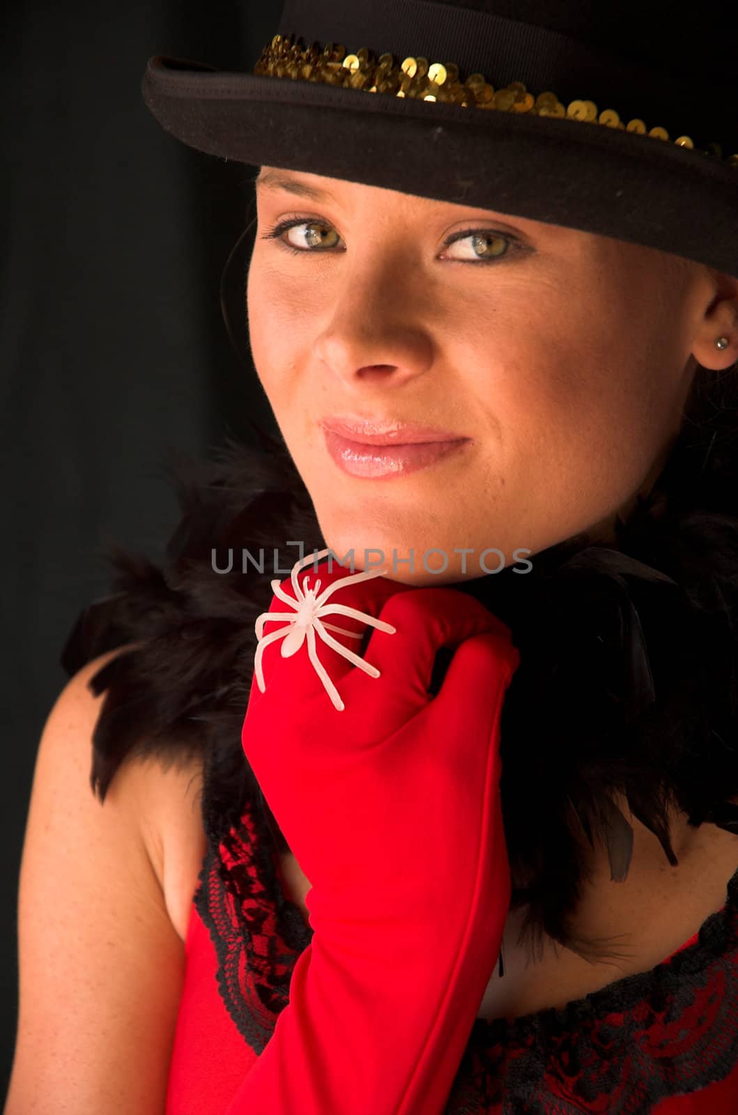 Moulin Rouge model with hat and red gloves holding hat on head with gold band and white ring spider