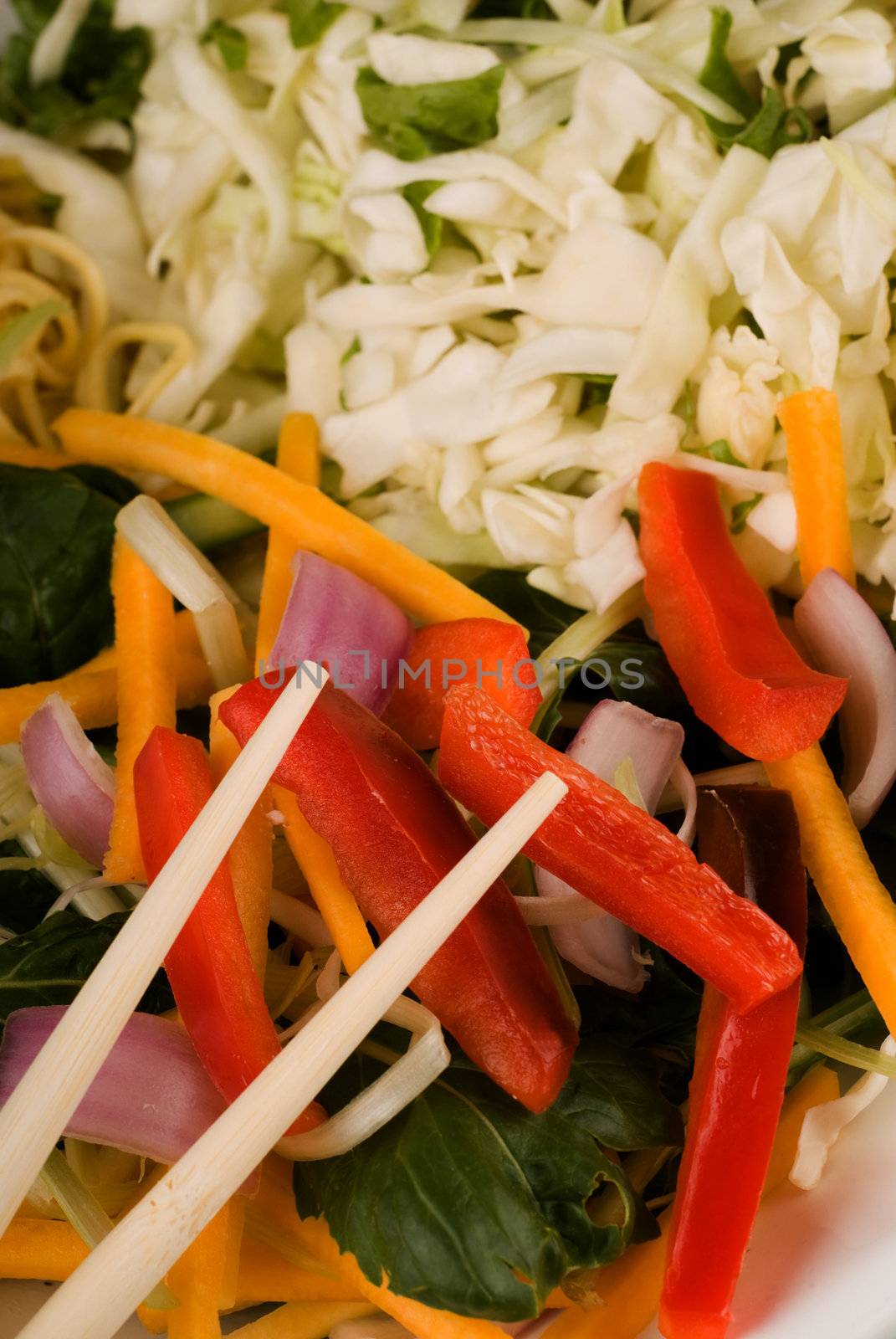 Chop sticks and raw thai food stir fry