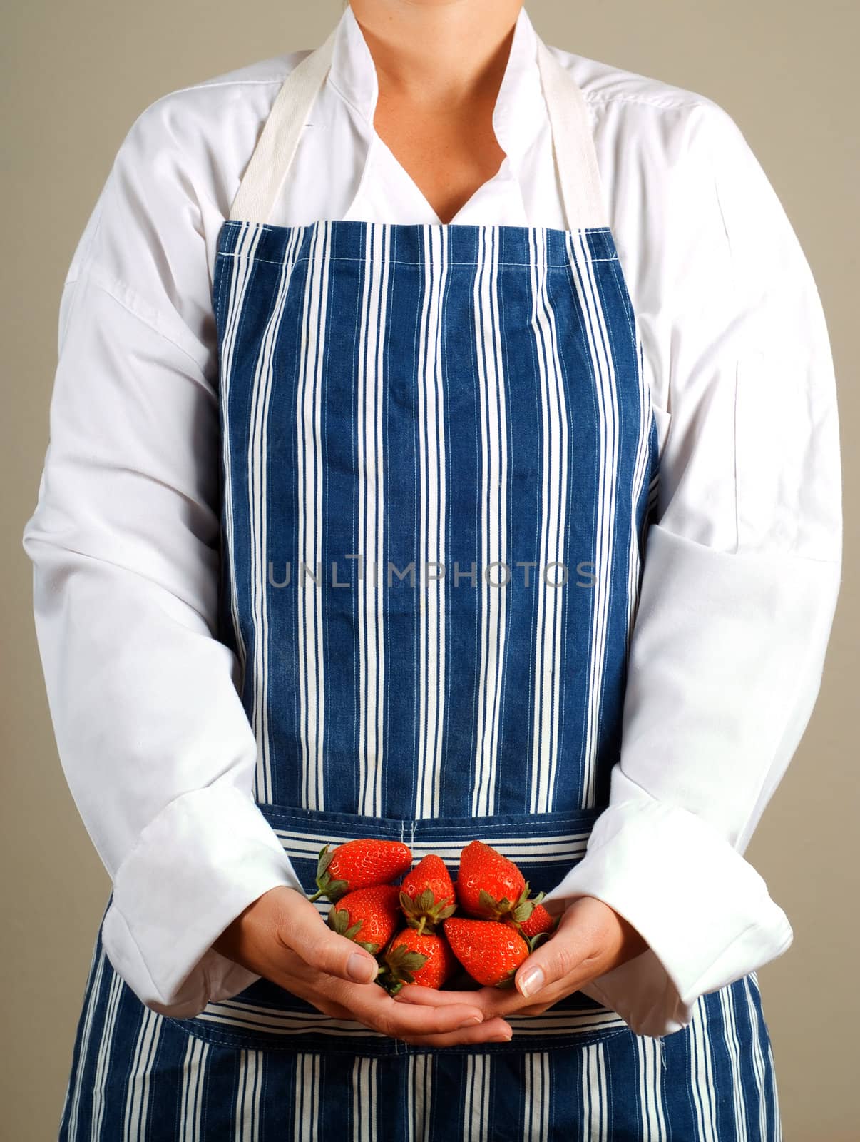 Woman cook or chef holding strawberries in her hands