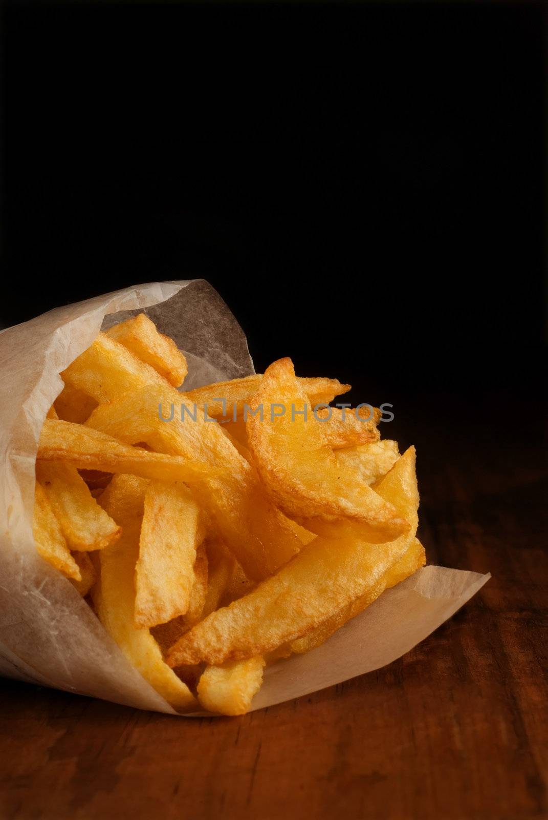 French fries in rolled newspaper packet or packaging