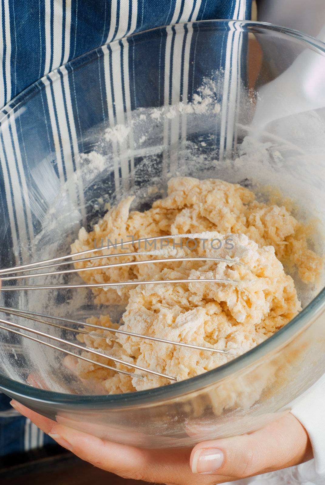 Woman chef cooking or baking and mixing pancake batter with whisk