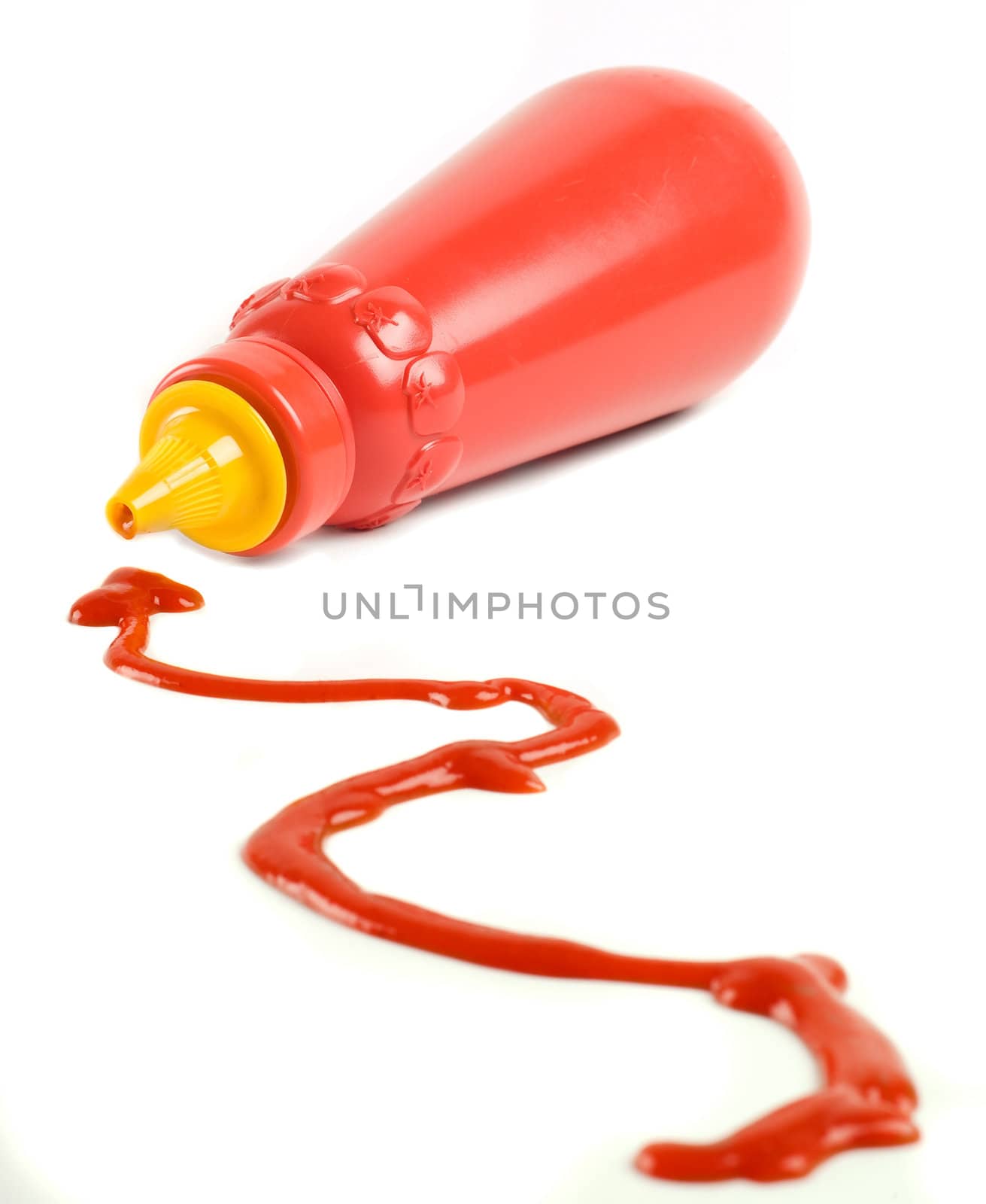 Red tomato ketchup bottle on side with trail of sauce