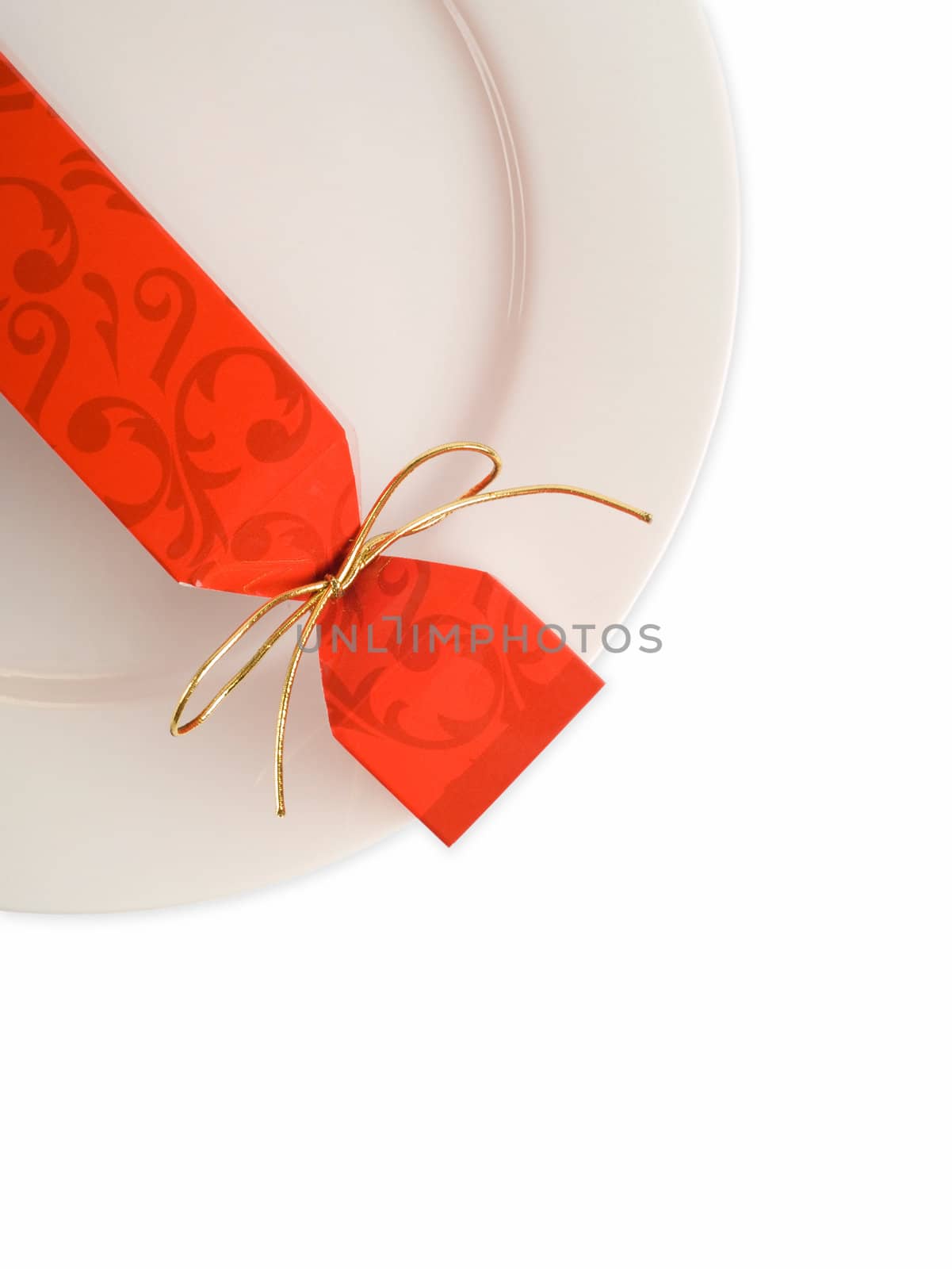 Christmas or party cracker on white dinner plate