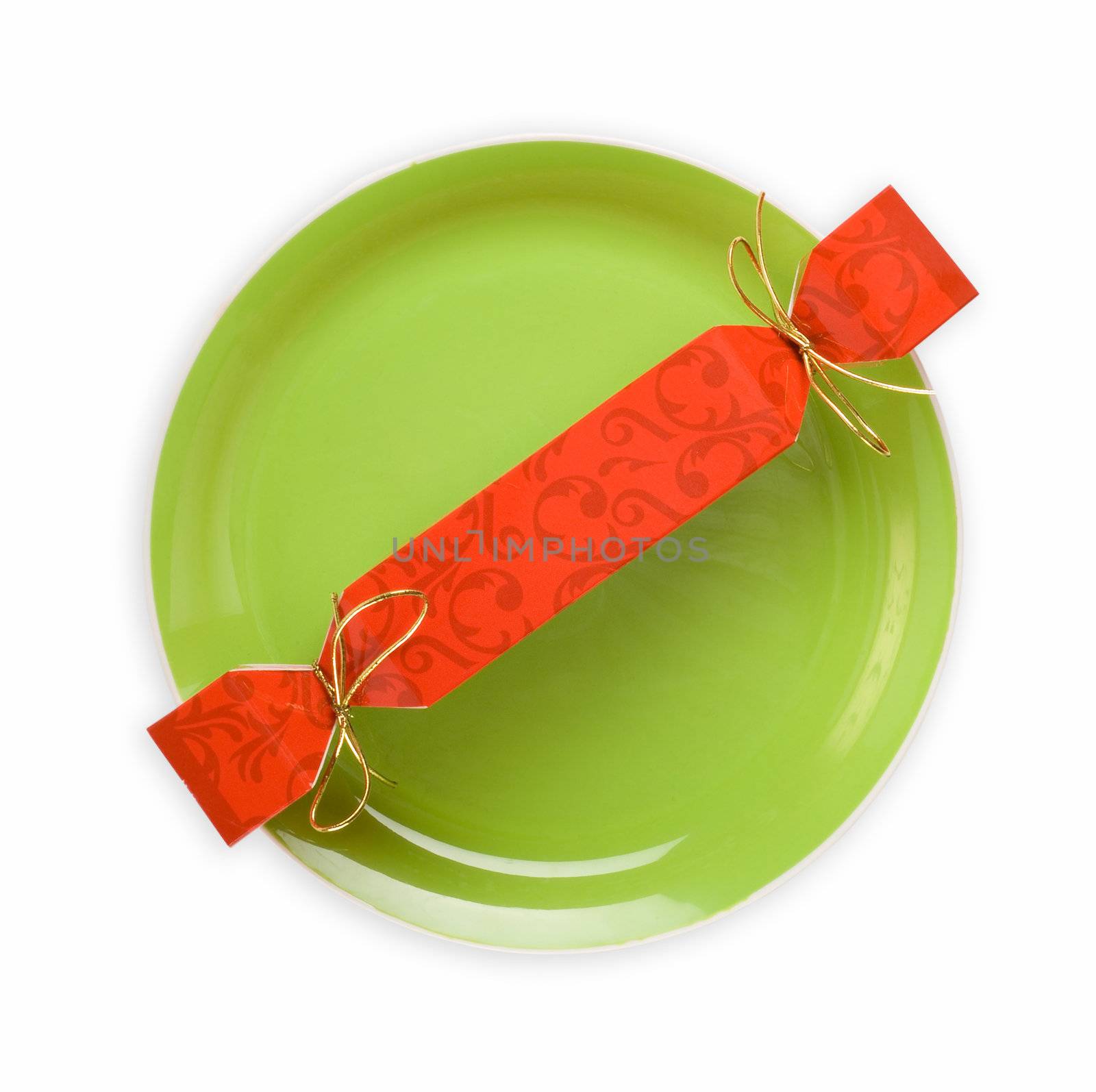 Christmas or party cracker on green dinner plate